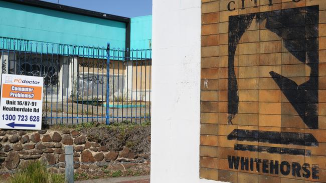 The abandoned building stands next to the ‘City of Whitehorse’ entry sign. Picture: Stuart Milligan