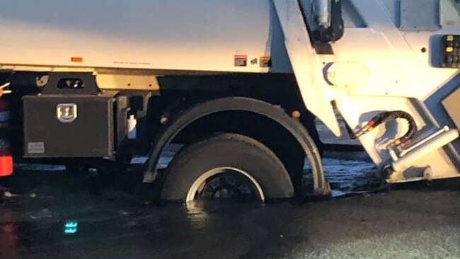 A garbage truck's rear wheel became lodged in the road at Narrabeen. Picture: Facebook