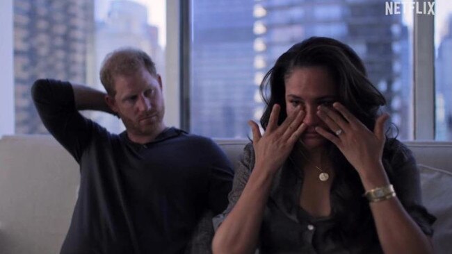 Meghan Markle wipes her eyes as a concerned Prince Harry looks on. Picture: Netflix