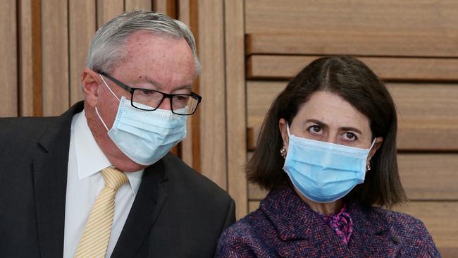 NSW Minister for Health and Medical Research Brad Hazzard speaks with NSW Premier Gladys Berejiklian during a Covid update on Friday.