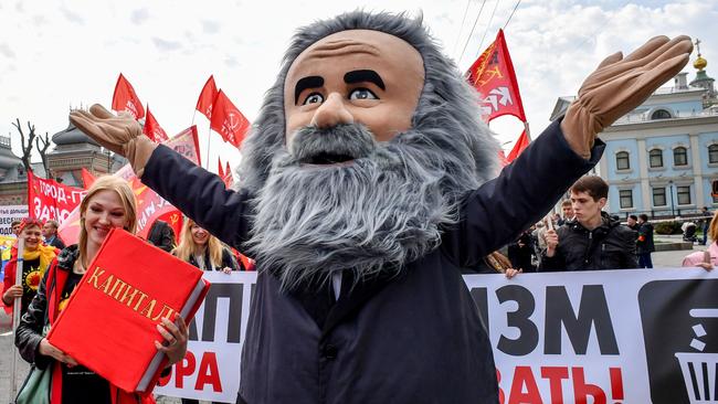 A demonstrator dressed as Karl Marx marches along with activists and supporters during a May Day rally in Moscow.