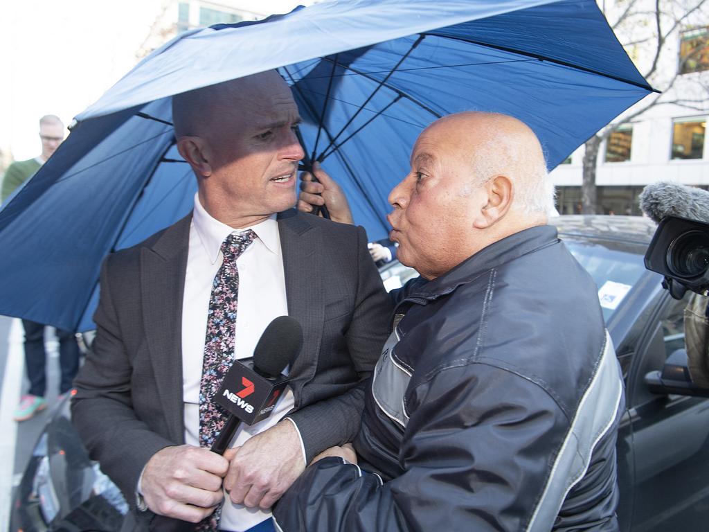 Channel 7 reporter Paul Dowsley (left) is confronted by Lydia Abdelmalek’s father in 2019. (AAP Image/Ellen Smith)