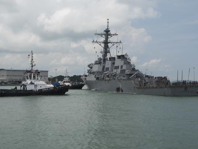 Tugboats from Singapore assist the damaged guided-missile destroyer USS John S. McCain (DDG 56) dock following a collision with the merchant vessel Alnic MC. Picture: USN