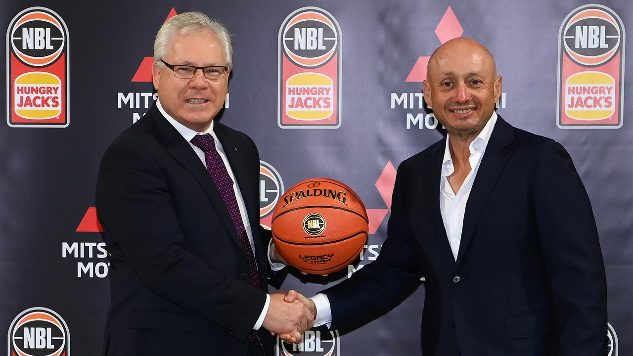 Mitsubishi CEO Shaun Westcott shakes hands with Larry Kestelman. (Photo by Quinn Rooney/Getty Images for NBL)