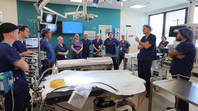 Surgeon Joe Crameri (third from right) addresses the surgery team behind the marathon operation to separate Nima and Dawa at the Royal Children's Hospital in Melbourne. Picture: Alex Coppel