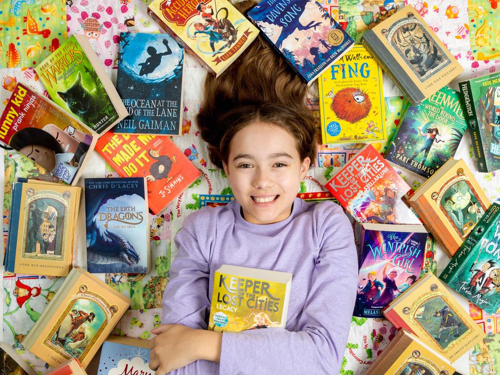 Winner of the Orange level (Years 5-6) category, 10-year-old Jillian Strong, pictured at home with some of her favourite books, is a big reader – but the only word she got wrong was the publishing term “frontispiece”. Picture: Richard Walker