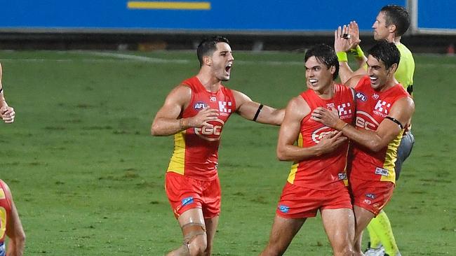 Jack Bowes (2nd right) of the Suns celebrates after scoring a goal during the round one AFL match between the Gold Coast Suns and the North Melbourne Kangaroos at Cazaly's Stadium on March 24, 2018 in Cairns, Australia. (Photo by Ian Hitchcock/Getty Images)