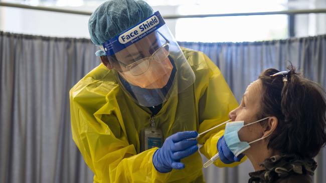 MANLY DAILY. Northern Beaches Hospital Covid 19 clinic photographed today 18th August 2020. Nurse Cathy Morris in the hot zone of the clinic performing a test on a patient. Image Matthew Vasilescu