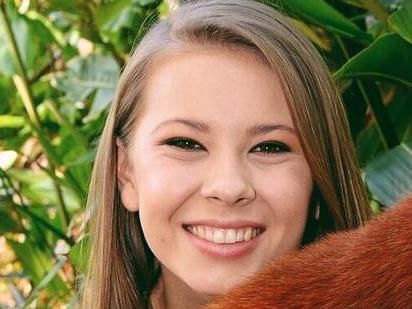 Ravi the red panda with Bindi Irwin at Australia  Zoo . Picture: Australia Zoo