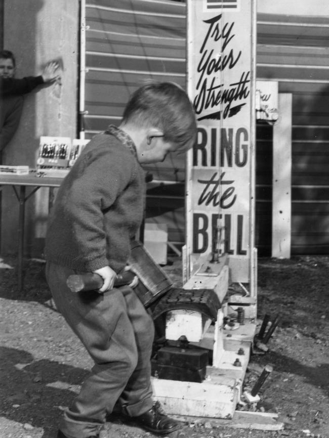 1963 — Michael Gogler, 4, of Westbourne Park, struggles with the heavy sledge in an attempt to ring the bell