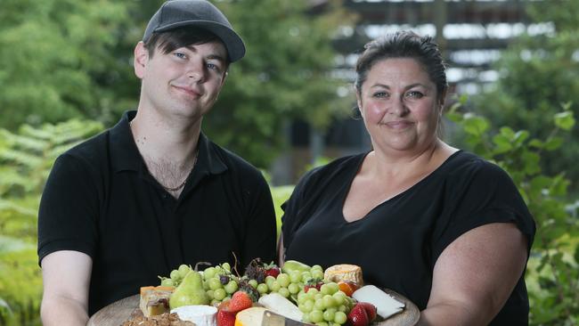 Cheese-a-holics is running a new cheese festival at the Tonsley Innovation District. Lauretta Whittaker and her son Brett Winter with cheese platter at the old Mitsubishi site. Picture: AAP/Emma Brasier