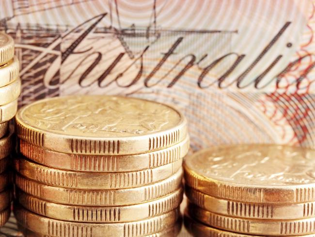 Australian money - coins, cash generic. Stacks of one dollar coins, with twenty dollar note behind.