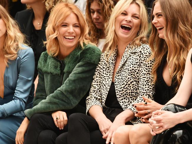 LONDON, ENGLAND - SEPTEMBER 21: (L to R) Suki Waterhouse, Sienna Miller, Kate Moss, Cara Delevingne, St Vincent and Naomie Harris attend the Burberry Womenswear Spring/Summer 2016 show during London Fashion Week at Kensington Gardens on September 21, 2015 in London, England. (Photo by David M. Benett/Dave Benett/Getty Images for Burberry)