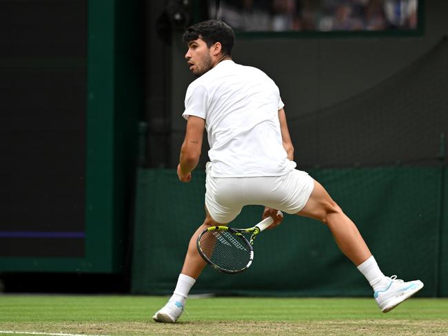 LONDON, ENGLAND - JULY 09: Carlos Alcaraz of Spain plays a shot between the legs against Tommy Paul of United States in the Gentlemen's Singles Quarter Final match during day nine of The Championships Wimbledon 2024 at All England Lawn Tennis and Croquet Club on July 09, 2024 in London, England. (Photo by Mike Hewitt/Getty Images)