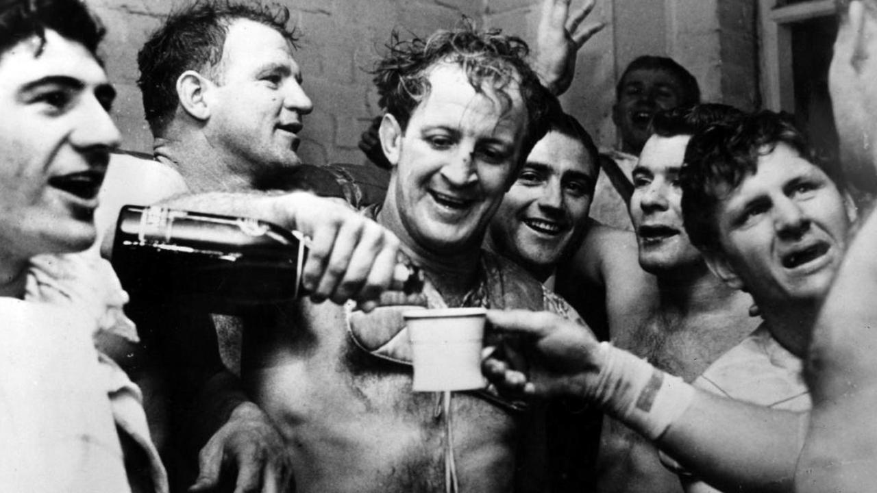 Johnny Raper pours champagne for his Kangaroos teammates after a win over Great Britain