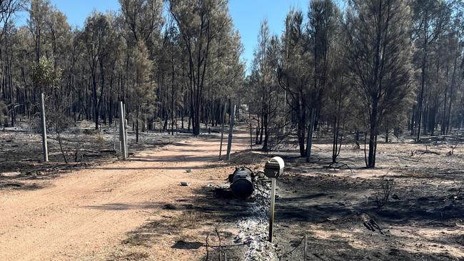 Ergon Energy workers trying to restore power following multiple power poles burnt to ashes in Tara. Picture: Ergon Energy