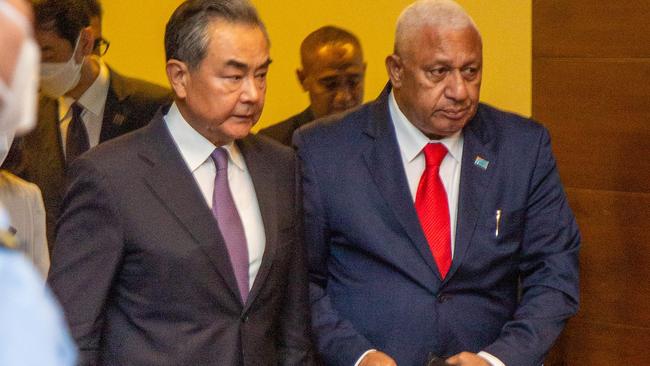 Chinese Foreign Minister Wang Yi with Fijian Prime Minister Frank Bainimarama in Suva. Picture: AFP.