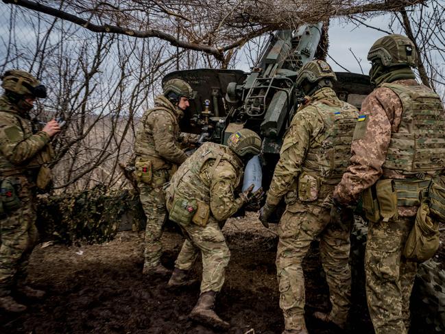 Ukrainian servicemen load a shell into a howitzer. Picture: Dimitar Dilkoff/AFP