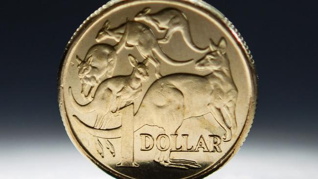 An Australian one-dollar coin is arranged for a photograph in Sydney, Australia, on Wednesday, April 17, 2013. Direct trading between the Australian dollar and yuan started on April 10. Photographer: Ian Waldie/Bloomberg