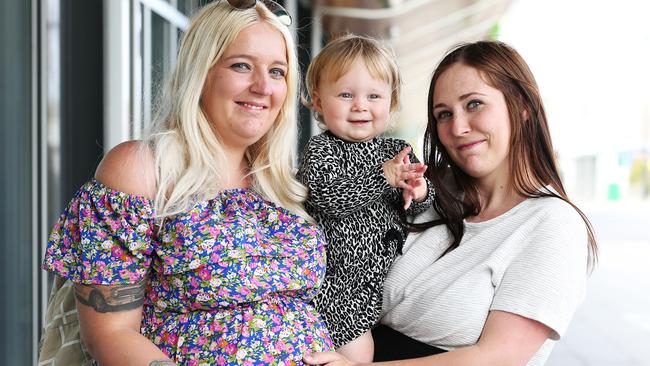 Patricia Carter (left) is reunited with sister Jennifer Carter and niece Brianna Moore, 1 after being away for 18 months. Picture: Zak Simmonds