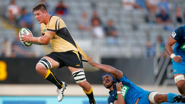 Richard Hardwick of the Force is tackled at Eden Park.