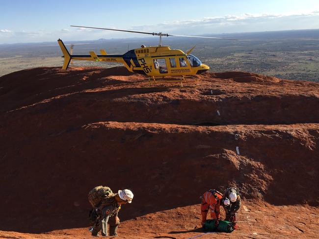 Three Australians were rescued after falling into a crevice on Uluru.