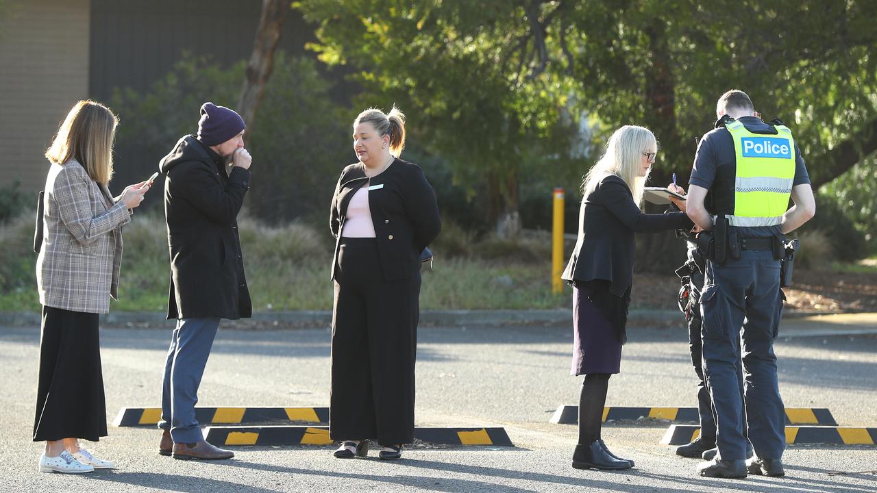 Staff speak with police after a fire caused significant damage to the Hendy St Northern Bay College campus. Picture: Alison Wynd