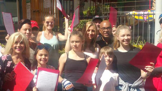 Residents with former city councillor Eddy Sarroff as they plan a petition to save the Broadbeach carousel.