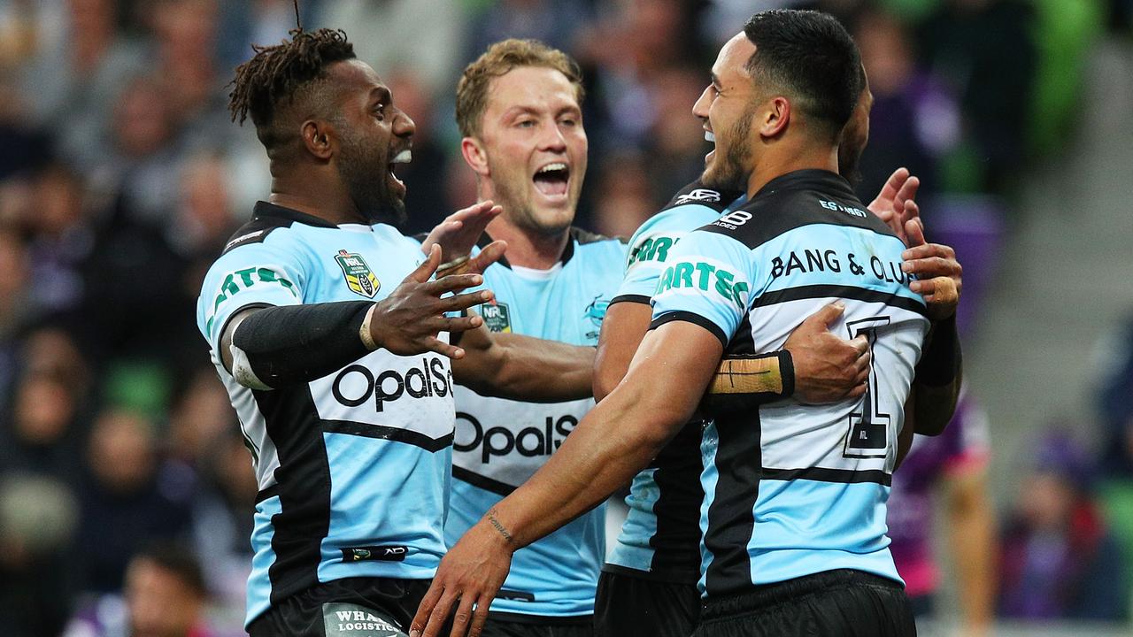 Valentine Holmes of the Sharks is congratulated by his teammates after scoring a try against the Storm.