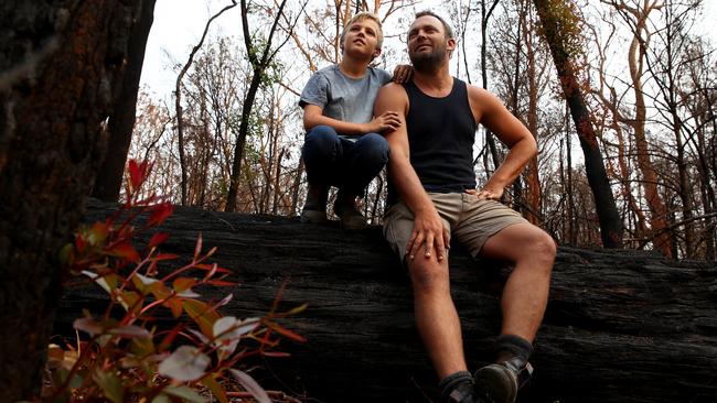 Arlo Ireland and his son Harper, 9, check out the new growth on their Mogo property after some rain. Picture: Toby Zerna