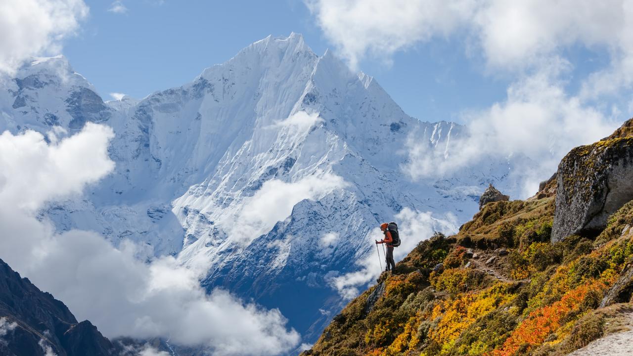 Hiker walking on train in Himalayas.