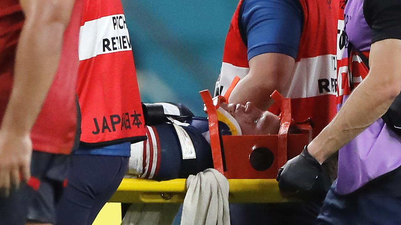 United States' Will Hooley was stretchered off the field after being concussed late in the game - but was subject to an illegal shot early on. (AP Photo/Christophe Ena)