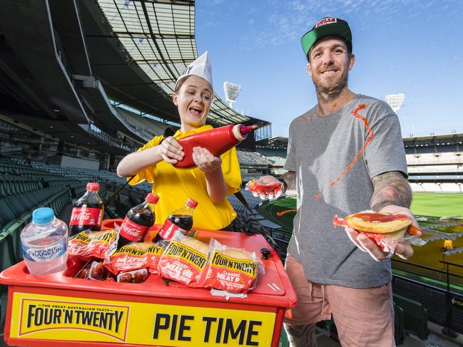 Pie vendor Bridget Schwerdt and Collingwood Browlow medallist Dane Swan share the meaty goodness. Picture: Jason Edwards