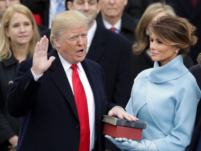 UPLOADED IMAGE -  WASHINGTON, DC - JANUARY 20: (L-R) U.S. President Donald Trump takes the oath of office as his wife Melania Trump holds the bible on the West Front of the U.S. Capitol on January 20, 2017 in Washington, DC. In today's inauguration ceremony Donald J. Trump becomes the 45th president of the United States.   Chip Somodevilla/Getty Images/AFP == FOR NEWSPAPERS, INTERNET, TELCOS & TELEVISION USE ONLY ==