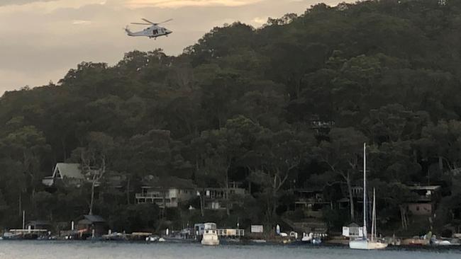 The NSW Ambulance helicopter, winching a boy from Scotland Island who had been badly injured when a golf buggy rolled on Thursday evening. Picture: NSW Ambulance