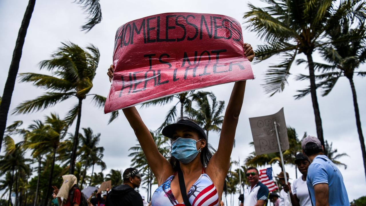 Protesters took up the chant “Fake news is not essential” at a protest yesterday morning. Picture: Chandon Khanna/AFP