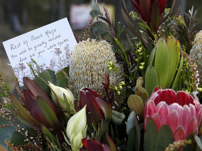 Floral tributes including one from the work mates of Kane left near the scene of the horrific bus crash. Picture: Jonathan Ng