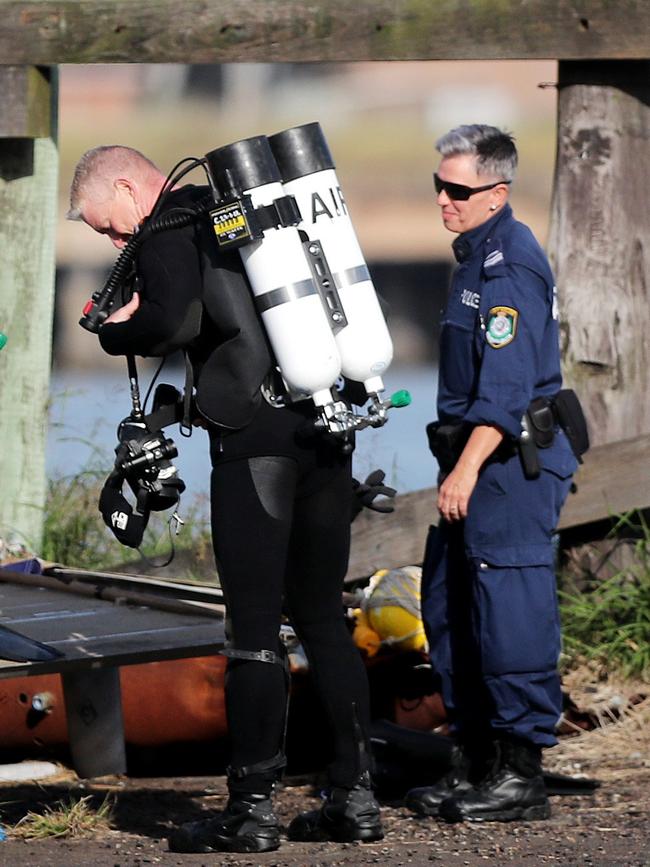 Police divers suiting up to investigate the scene. Picture: Peter Lorimer