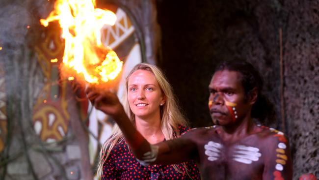 Ginlare Tamulevicirte from Lithuania watches on as Tjapukai performer Warrick Newbury gets a fire started after creating hot embers with a fire stick. PICTURE: STEWART MCLEAN