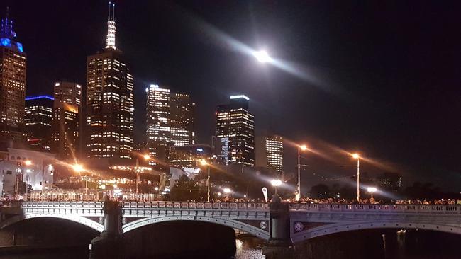 The full moon rises above Melbourne's CBD. Picture: Shaun Campbell