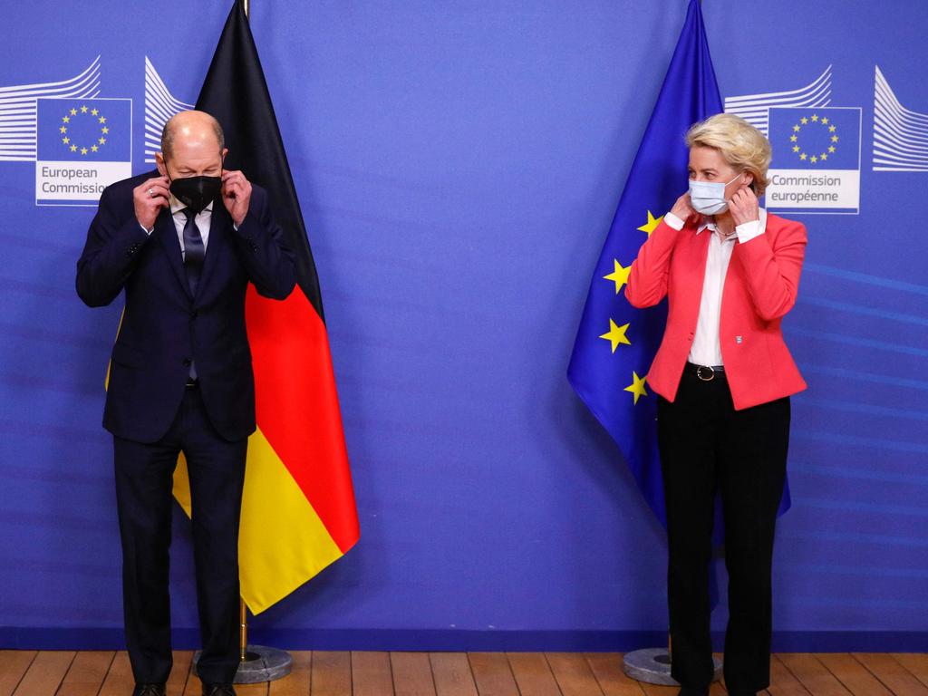 President of the European Commission, Ursula von der Leyen (R) and German Chancellor Olaf Scholz adjust their protective face masks at the European Commission in Brussels. Picture: AFP