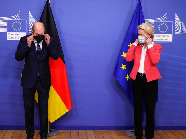 President of the European Commission, Ursula von der Leyen (R) and German Chancellor Olaf Scholz adjust their protective face masks at the European Commission in Brussels. Picture: AFP