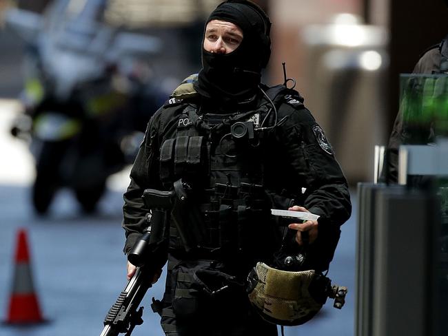 SYDNEY, AUSTRALIA - DECEMBER 15:  An armed policeman is seen in Phillip St on December 15, 2014 in Sydney, Australia.  Police attend a hostage situation at Lindt Cafe in Martin Place.  (Photo by Mark Metcalfe/Getty Images)