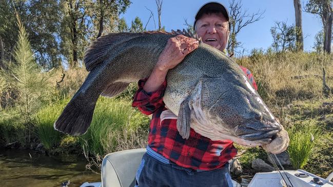 Robert Styan shows off his "monster fish", estimated to be 40kg, caught off the Glenlyon Dam Holiday Cottage.