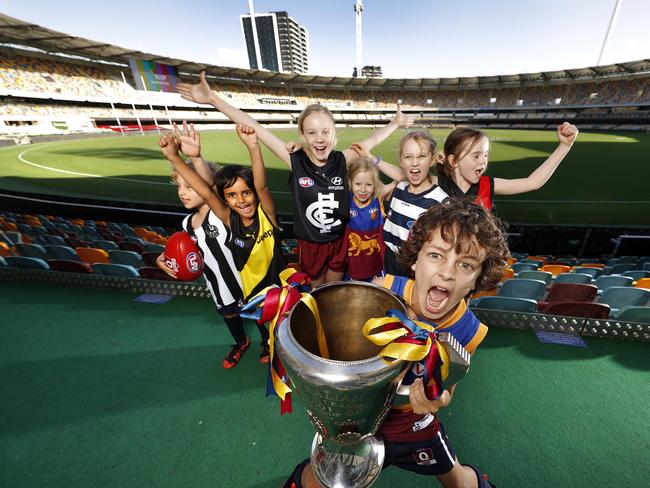 Local footy fans Blair Mackintosh, 6, Spencer Moore, 5, Sienna Hoare, 8, Charlotte Ensor, 7, <br/>Juliet Mackintosh, 9, Olivia Hoare, 6, and Archie Moore, 7, (front) celebrate the AFL grand final coming to the Gabba.