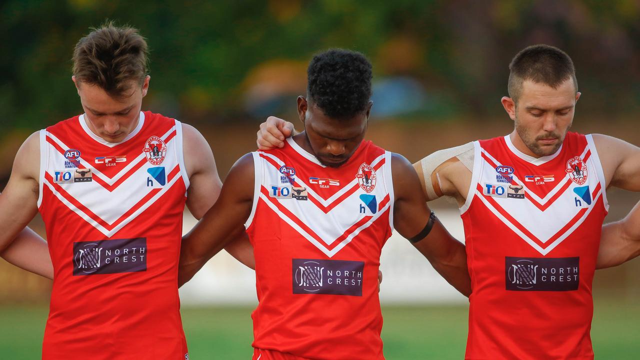 Waratahs observe a 30 second silence to commemorate the life of lost mate Alexander Aurrichio as history made at Gardens Oval with the first game under lights as Waratahs V Palmerston. Picture GLENN CAMPBELL