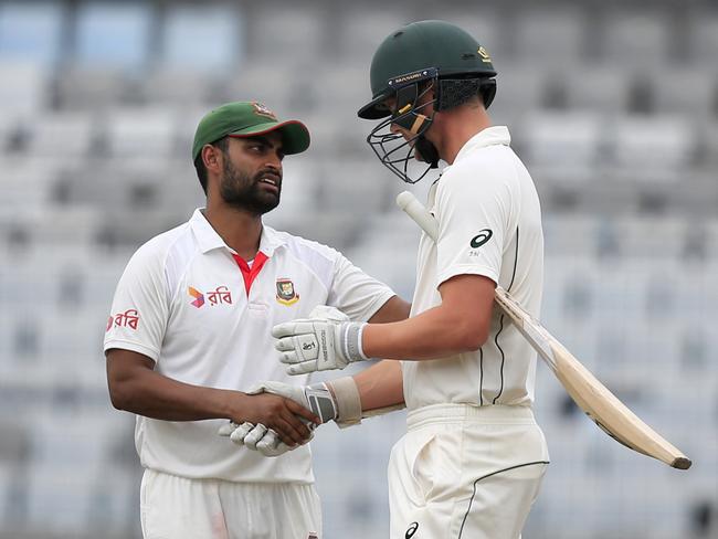 Bangladesh's Tamim Iqbal, left, shakes hand with Australia's Pat Cummins after the game.