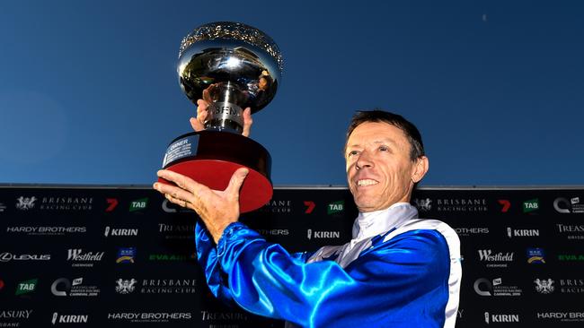 Michael Cahill poses with the trophy after riding The Bostonian to victory in the Doomben 10,000 earlier this year.
