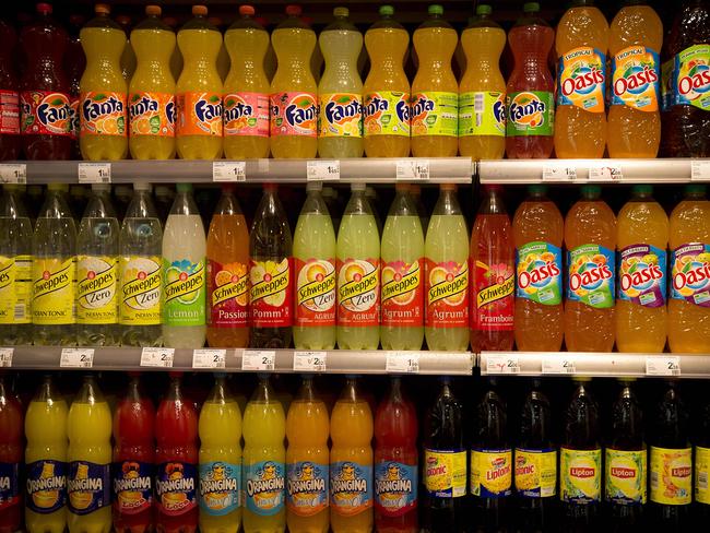 (FILES) This file photo taken on May 9, 2014 shows various soda bottles on display at a supermarket  in Paris. In a report to be unveiled on June 22, 2016, French lawmakers are suggesting to overtax sugary drinks to offset the suppression of other small taxes on food products, in the name of the simplification of the tax system, but also for public health reasons. / AFP PHOTO / JOEL SAGET