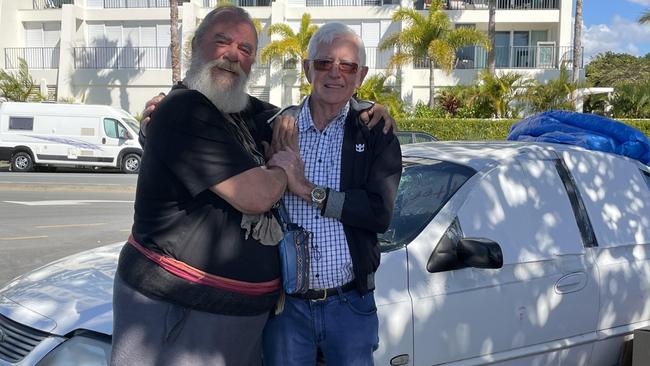 Edward Jacques and Merv Cassidy in Labrador with the smashed car. Picture: Melanie Whiting